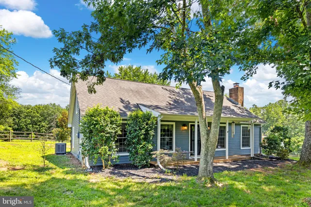 a view of grassy field with trees in the background