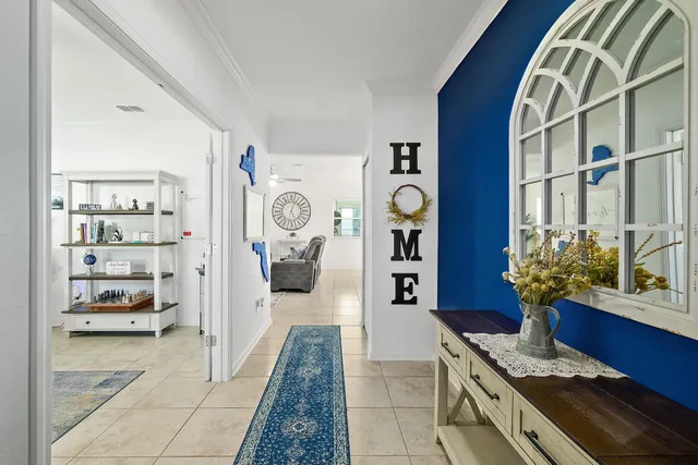 a hallway with painting on the wall and a window