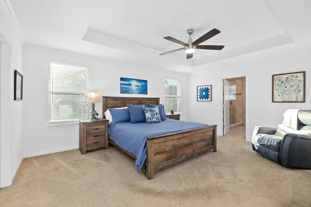 a spacious bedroom with a bed window and couch