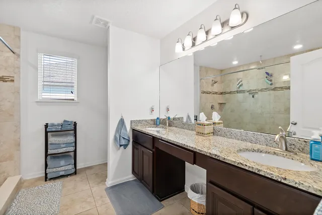 a bathroom with a sink double vanity and a mirror