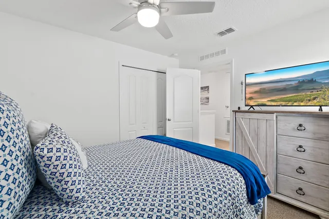 a bedroom with a bed and a dresser