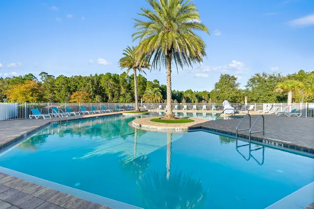 a view of swimming pool with chairs