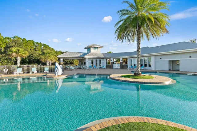 a swimming pool with outdoor seating and yard