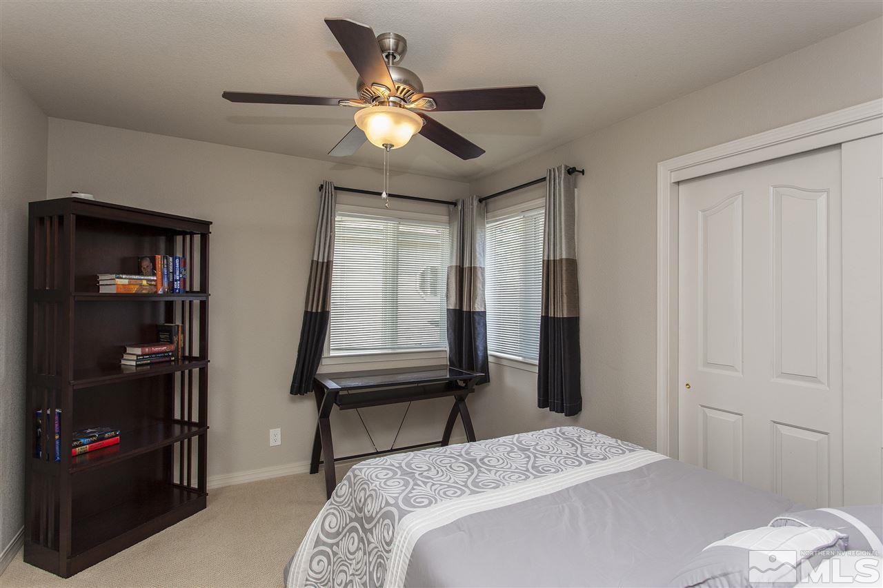 3985 Riverhaven Drive Reno, NV 89519 - Photo 16 of 25 a bedroom with a bed and a chandelier