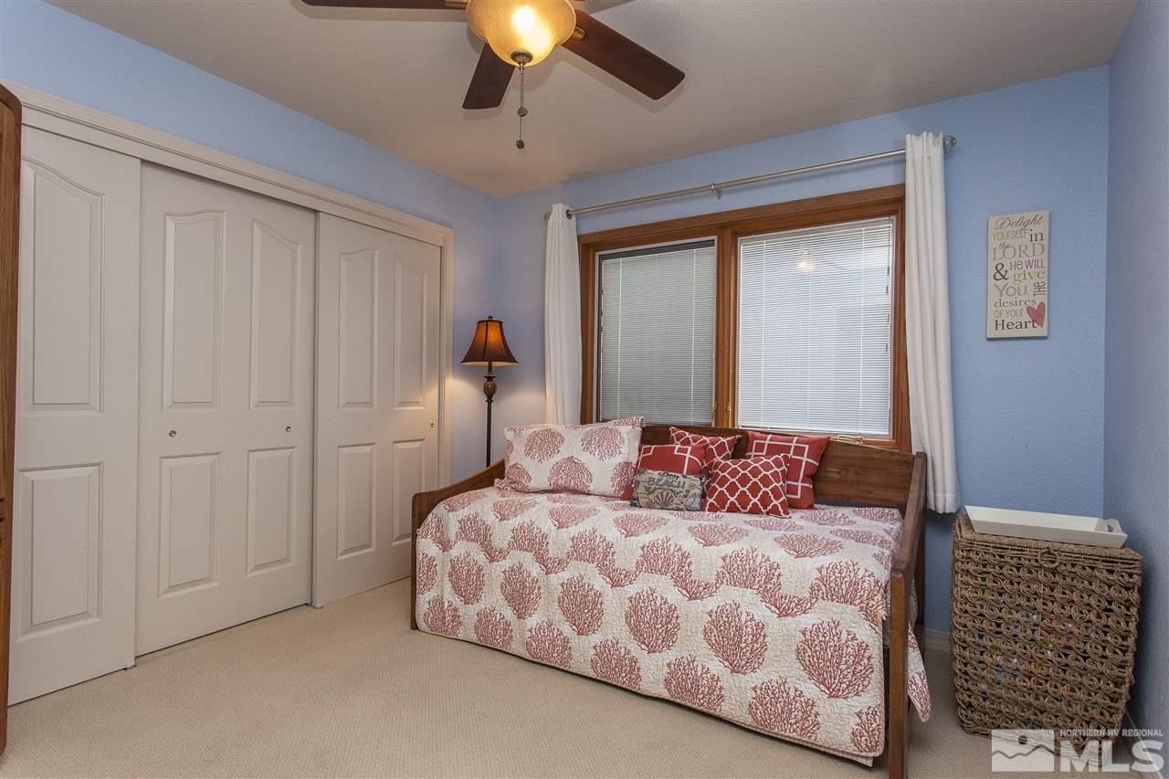 3985 Riverhaven Drive Reno, NV 89519 - Photo 20 of 25 a bedroom with a large bed and a chandelier