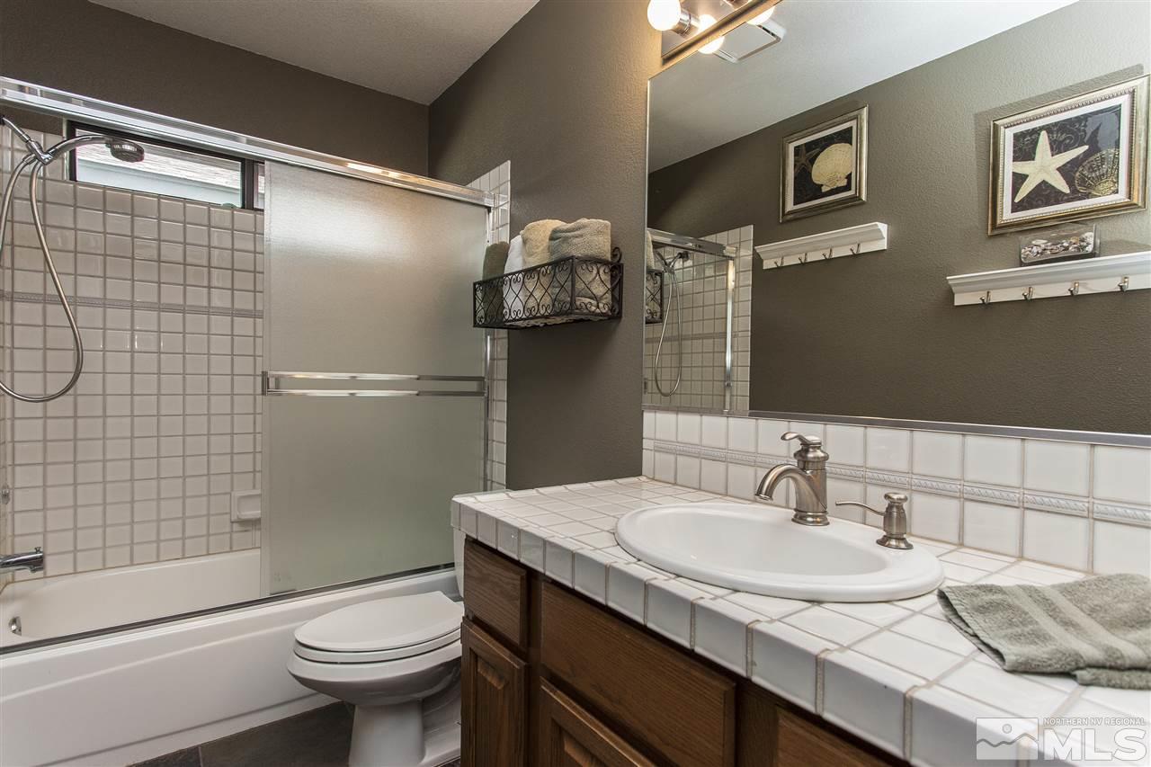 3985 Riverhaven Drive Reno, NV 89519 - Photo 21 of 25 a bathroom with a granite countertop sink toilet and shower