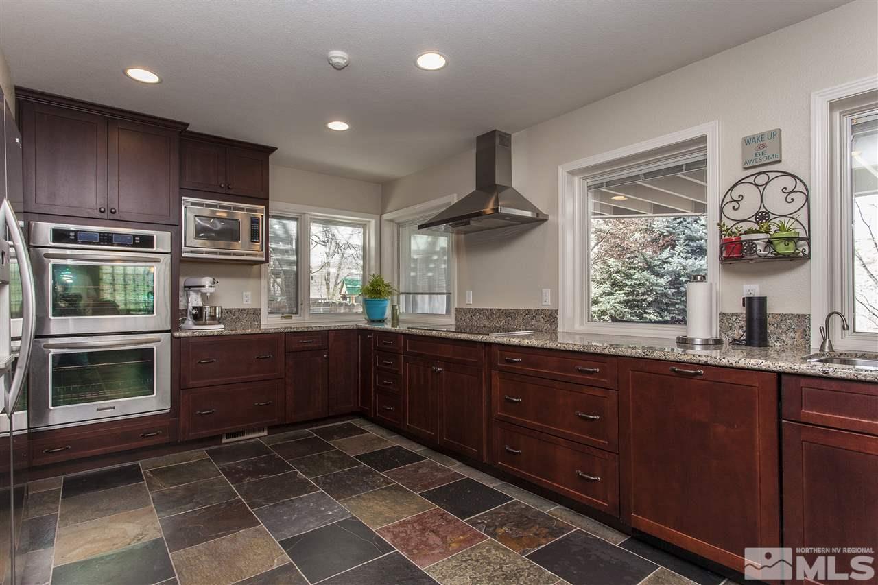 3985 Riverhaven Drive Reno, NV 89519 - Photo 8 of 25 a kitchen with stainless steel appliances granite countertop a stove a sink and a microwave