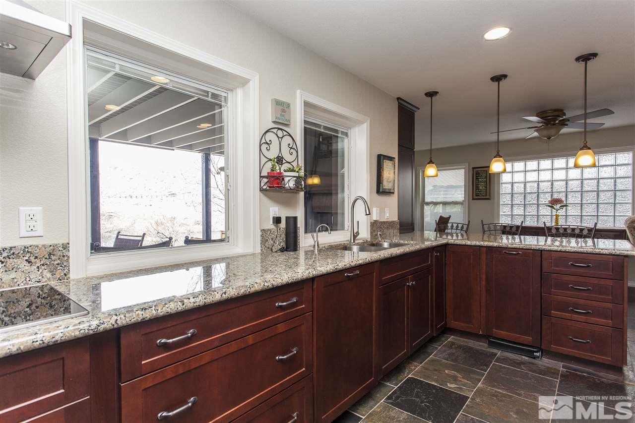 3985 Riverhaven Drive Reno, NV 89519 - Photo 9 of 25 a kitchen with granite countertop a sink and wooden floor