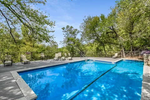a view of a swimming pool with an outdoor seating
