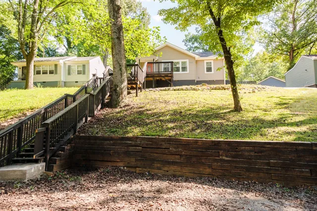 a view of a house with a yard from a balcony