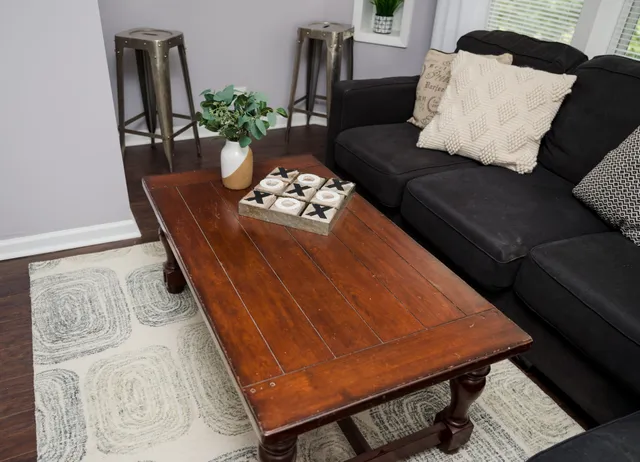 a living room with furniture and wooden floor