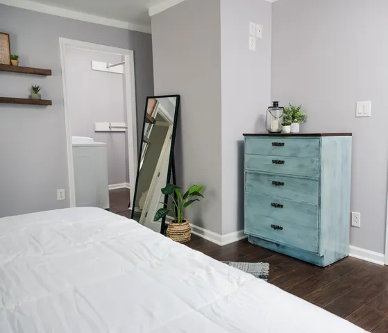 a bedroom with a bed and a dresser