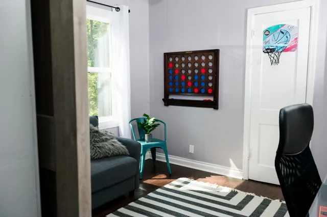 a bedroom with furniture and a window