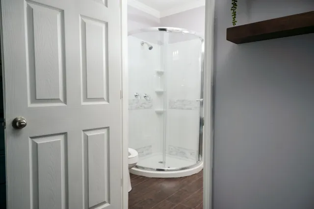 a bed sitting in a bedroom and a night stand