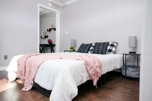 a bedroom with a bed and a window