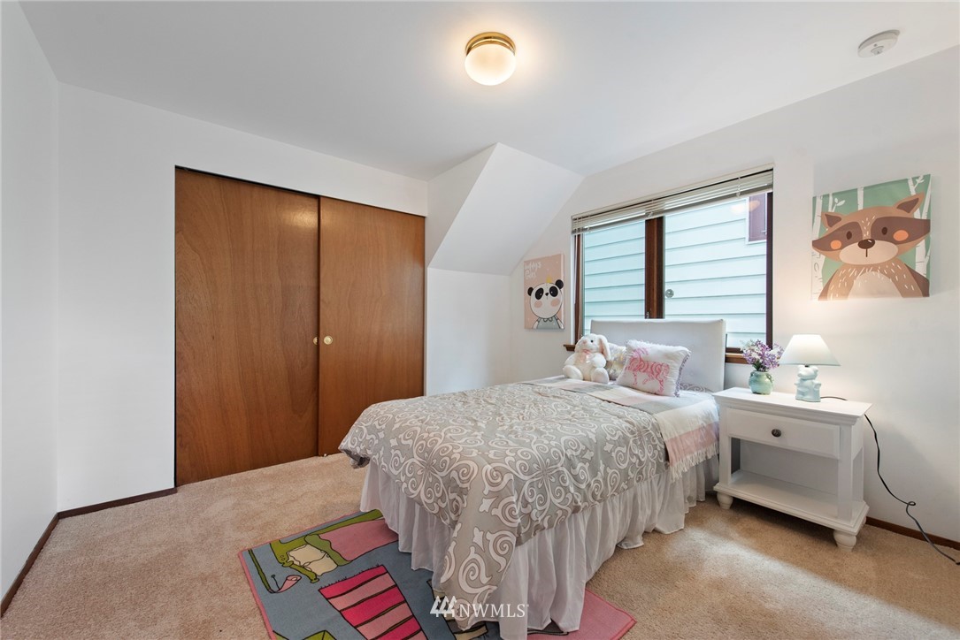 723 North 87th Street Seattle, WA 98103 - Photo 15 of 29 a bedroom with a bed and a window