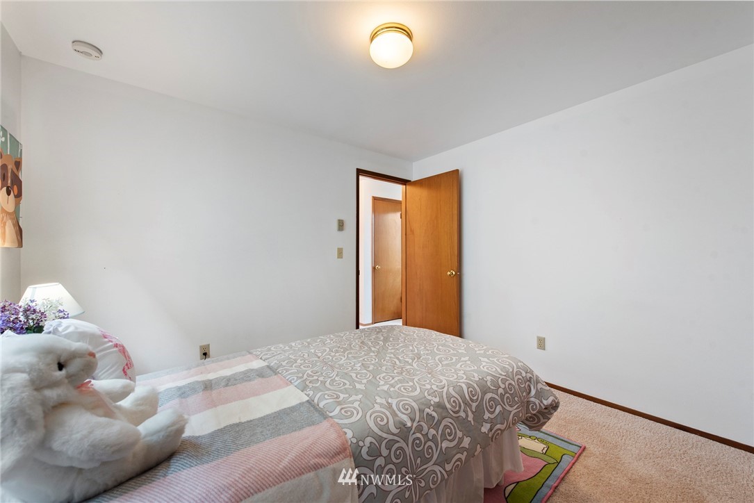 723 North 87th Street Seattle, WA 98103 - Photo 16 of 29 a bedroom with a bed and a window