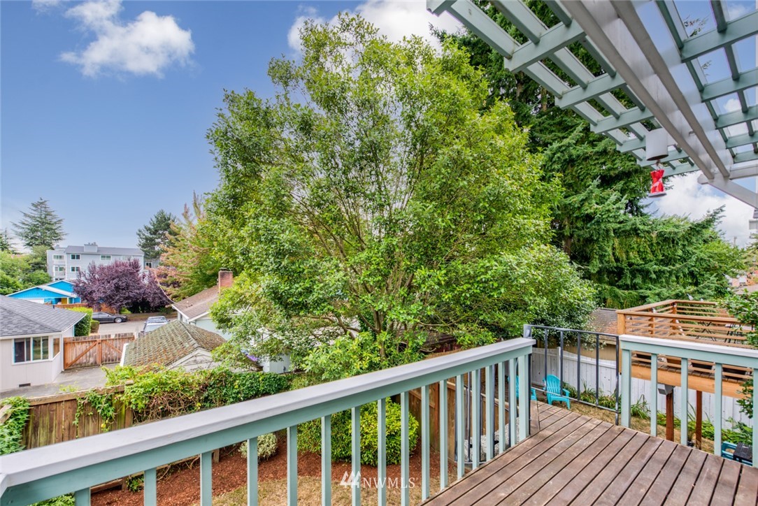 723 North 87th Street Seattle, WA 98103 - Photo 22 of 29 a balcony with wooden floor and outdoor seating