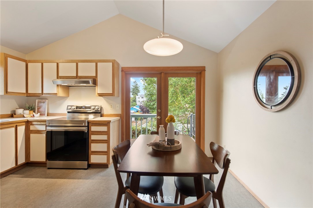 723 North 87th Street Seattle, WA 98103 - Photo 4 of 29 a kitchen with a table and chairs in it
