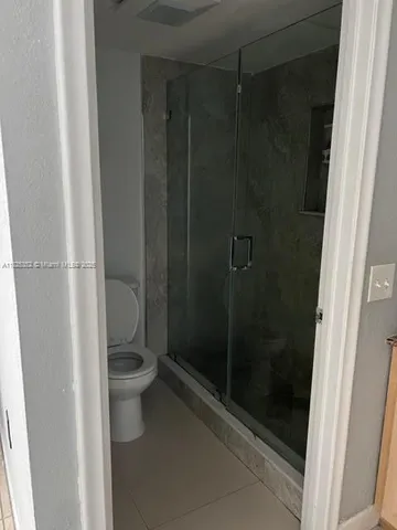 a bathroom with a shower and a toilet
