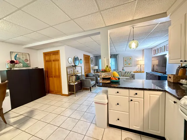 a kitchen with granite countertop a sink a counter space and cabinets