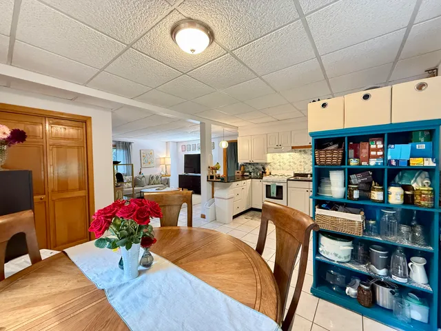 a living room with furniture and a book shelf