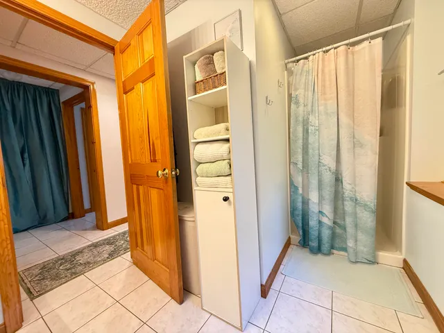 a view of a bathroom with a tub and shower