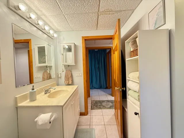 a bathroom with a sink a vanity and a mirror