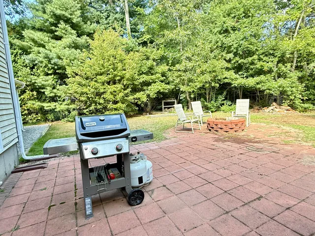a view of a yard with chairs