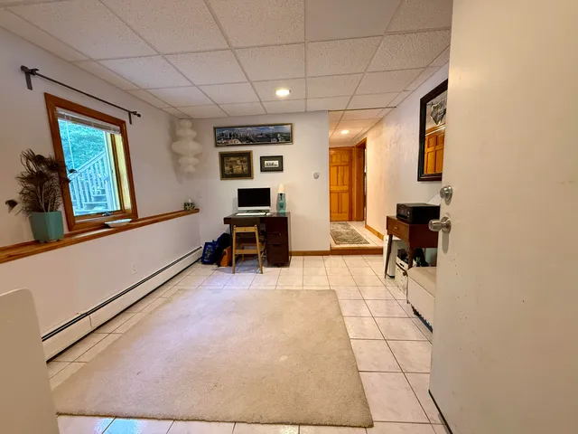 a view of a livingroom with workspace and a window