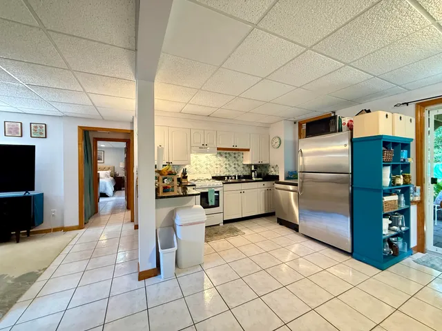a kitchen with cabinets and stainless steel appliances