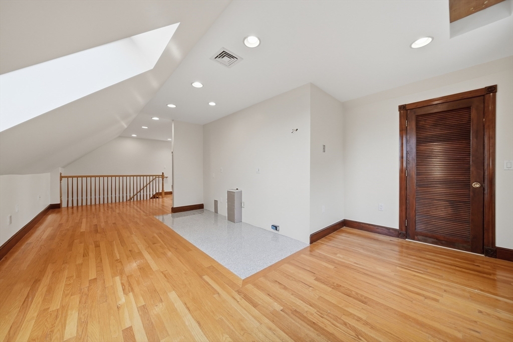 131 Range Heights Road Lynn, MA 01904 - Photo 21 of 36 a bedroom with a bed and wooden floor