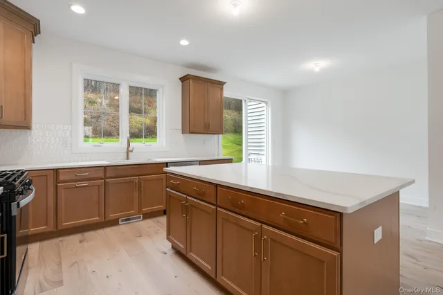 a kitchen with sink cabinets and window