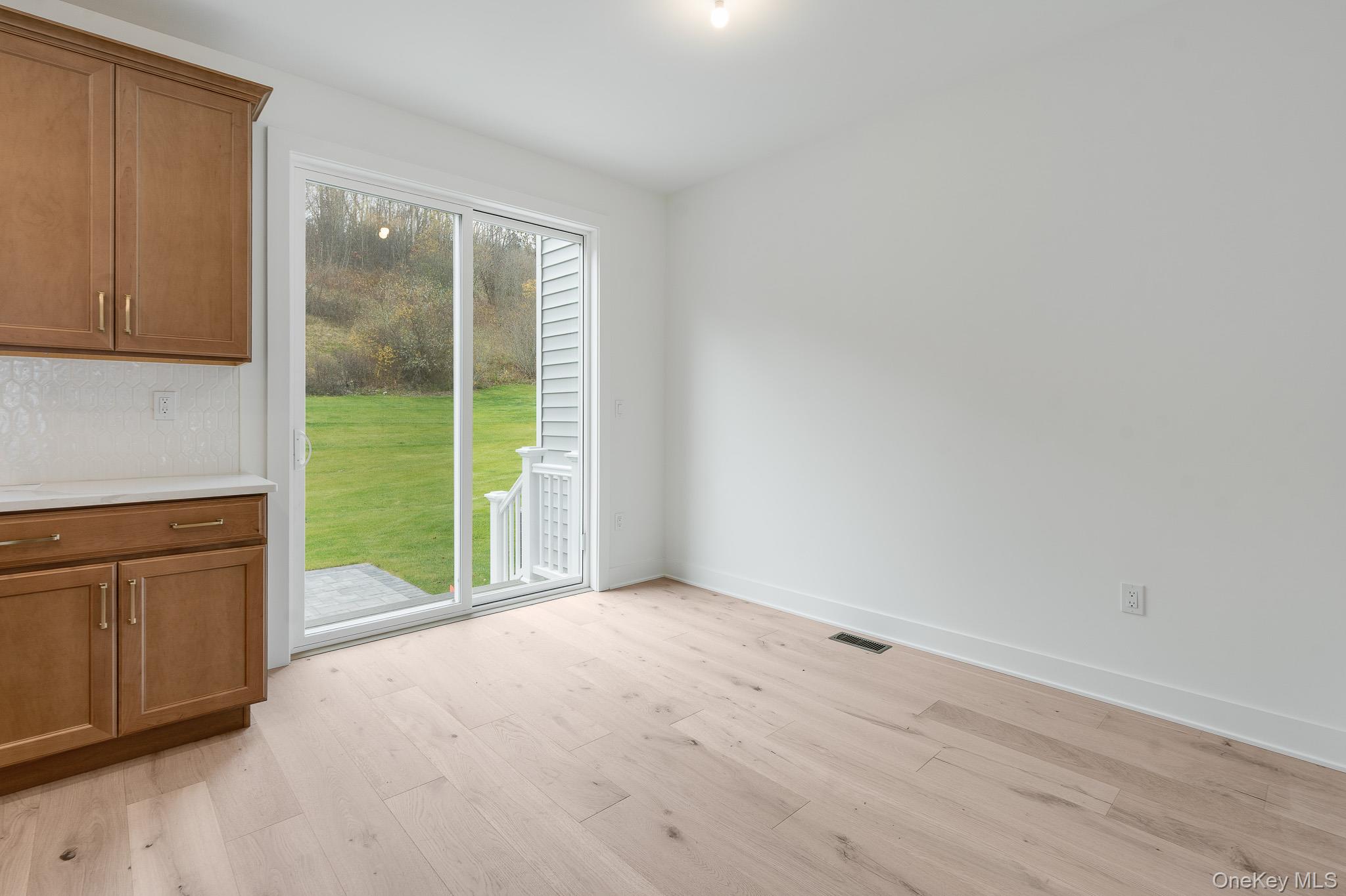 4044 Chestnut Rdg Road Fishkill, NY 12524 - Photo 4 of 26 a view of an empty room with a kitchen view and a window