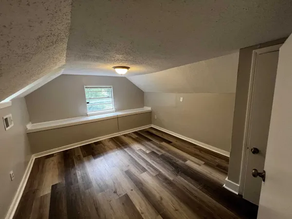 a view of an empty room and wooden floor