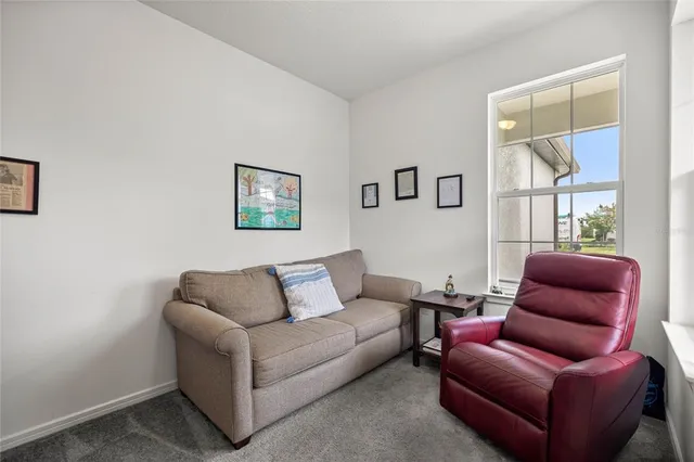 a living room with furniture a couch and windows