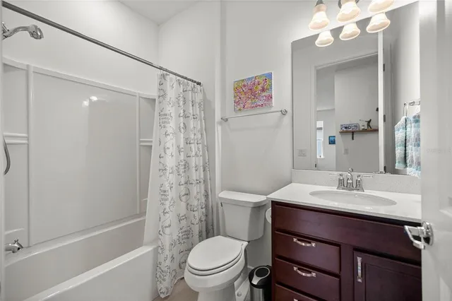a bathroom with a sink vanity mirror and toilet
