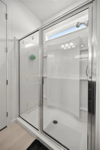 a bathroom with a glass shower door