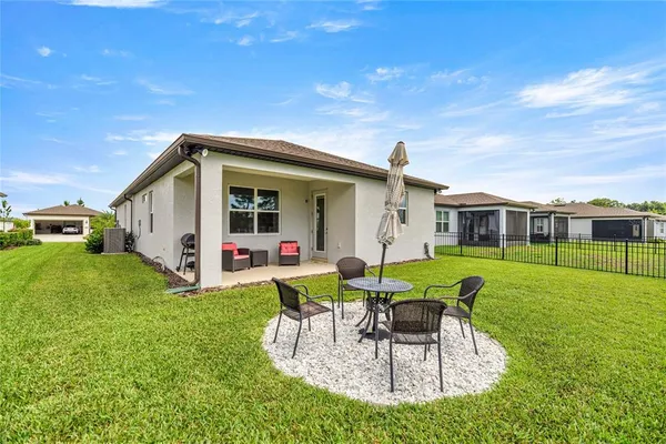 a front view of house with a garden and patio