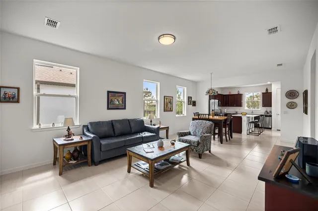 a living room with furniture a large window and a flat screen tv