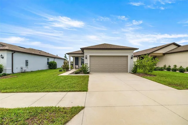 a front view of a house with a yard and garage