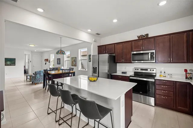 a kitchen with stainless steel appliances a stove refrigerator sink microwave and cabinets
