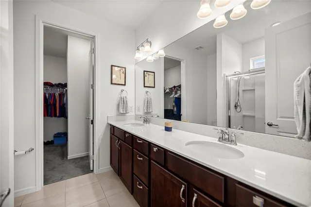 a spacious bathroom with a double vanity sink mirror and double