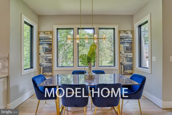 a kitchen with kitchen island granite countertop a sink a center island stainless steel appliances and cabinets