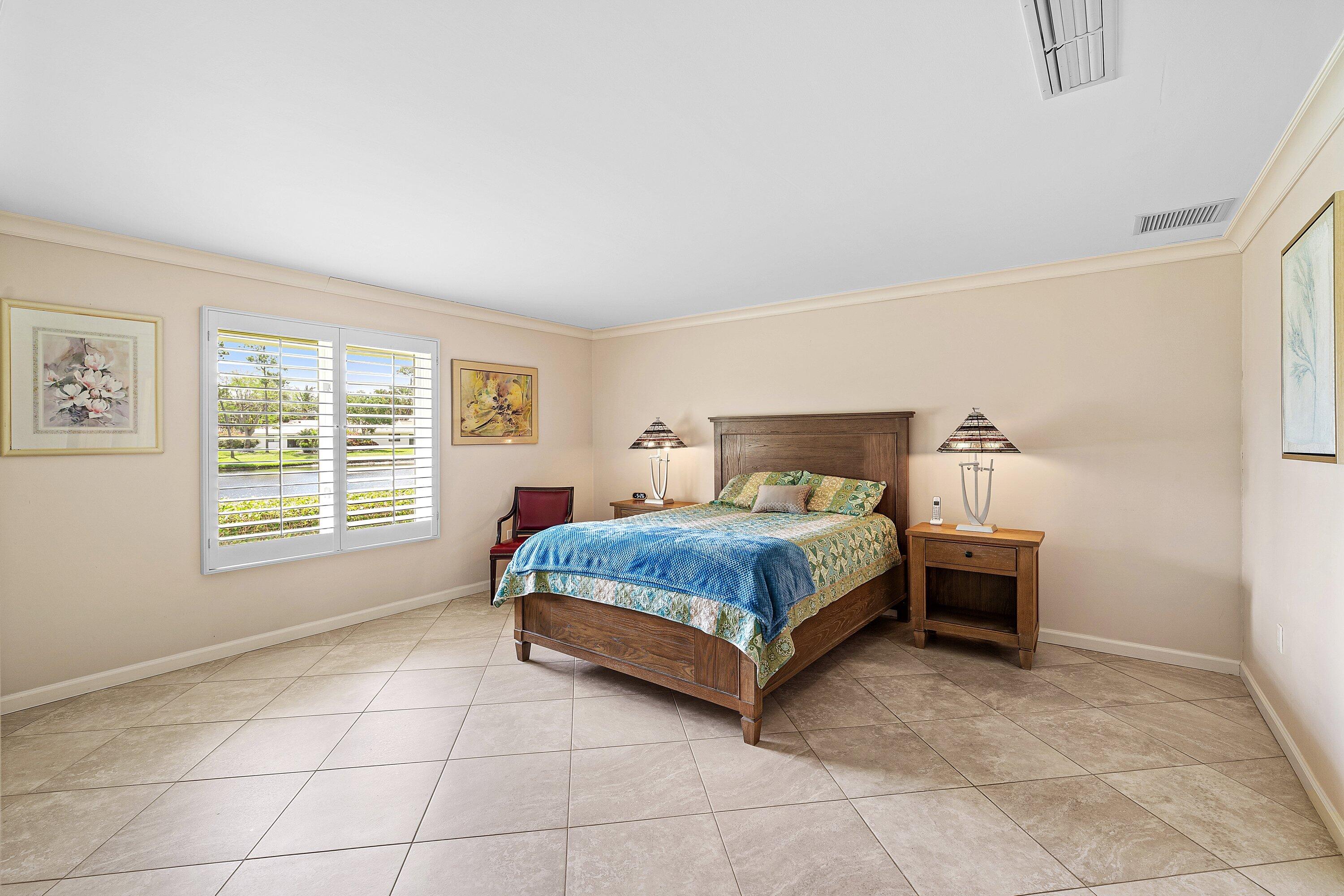 4365 Shell Drake Lane Boynton Beach, FL 33436 - Photo 18 of 56 a bedroom with a bed and window