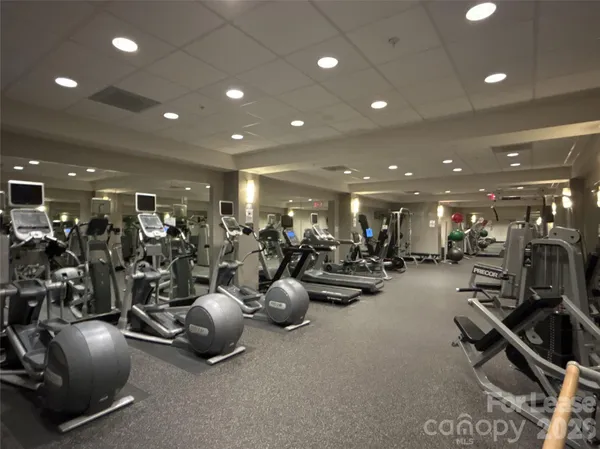 a room with gym equipment and a large mirror