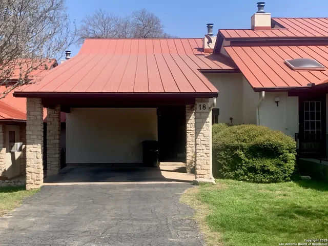 a view of small house with backyard