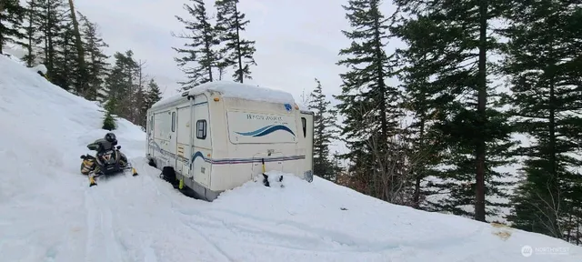 a white house covered with snow in the background