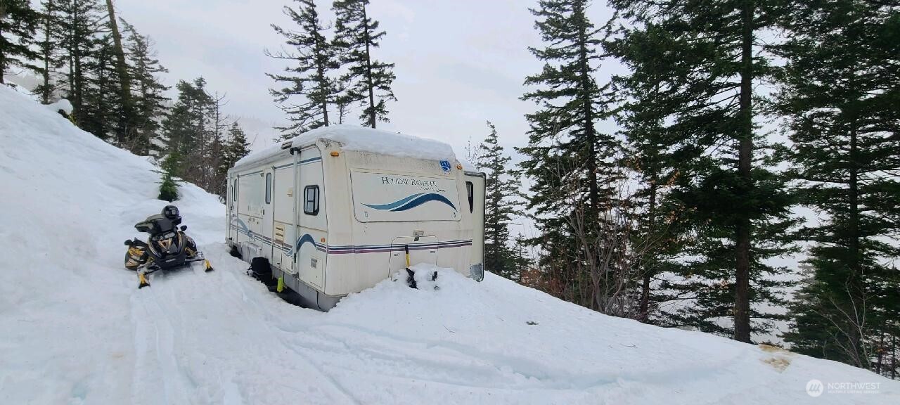 831 Horse Heaven Road Cle Elum, WA 98922 - Photo 9 of 32 a white house covered with snow in the background