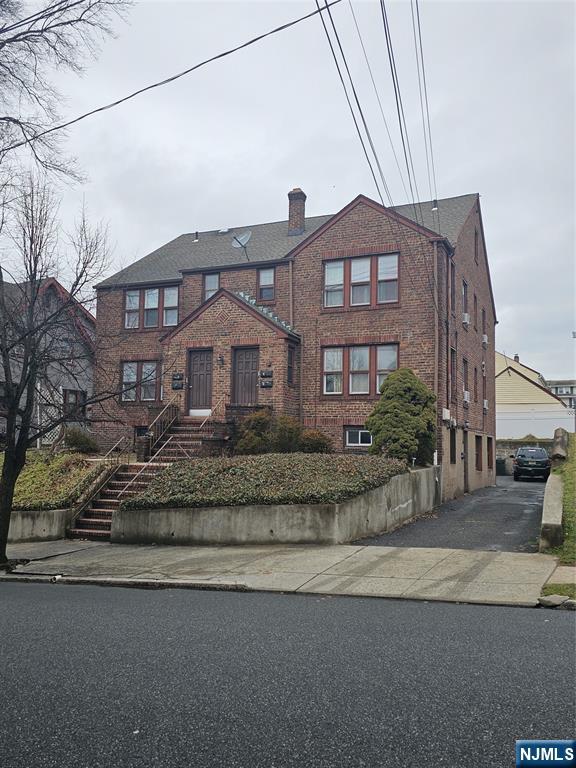 75 East Fort Lee Road, Unit 1 Bogota, NJ 07603 - Photo 2 of 8 a front view of a house with a yard